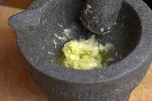 Wrijf de knoflook door de olijfolie